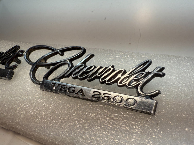 OEM 1971-75 Chevrolet Vega 2300 PAIR Emblem Nameplate Badge 9870383 B32-63