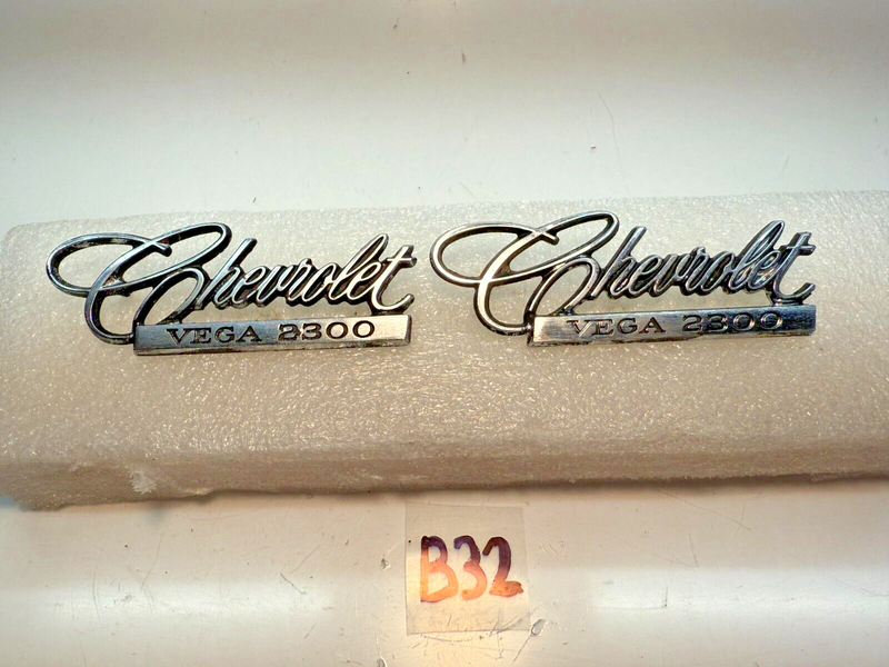 OEM 1971-75 Chevrolet Vega 2300 PAIR Emblem Nameplate Badge 9870383 B32-63